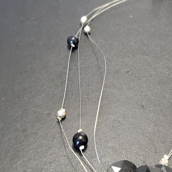 Silver tone black flower floating necklace - Picture 5 of 11